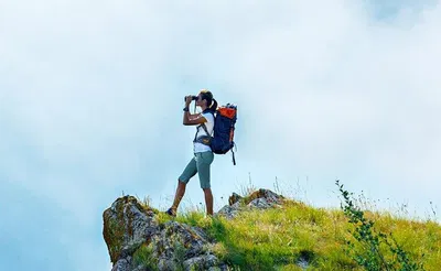 Girl standing on a cliff & surveying the Outback